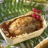 Four-meat terrine with red currants in a wooden baking mold